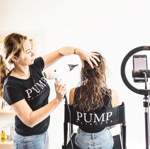 Tash blow drying a client's hair