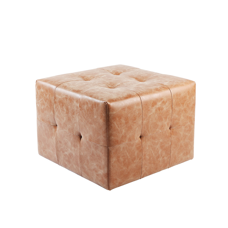 Cube ottoman in tan leather with a buttoned top