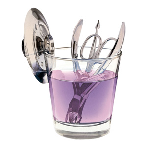 Glass manicurist sanitiser jar with a steel lid, holding scissors and nippers in violet solution